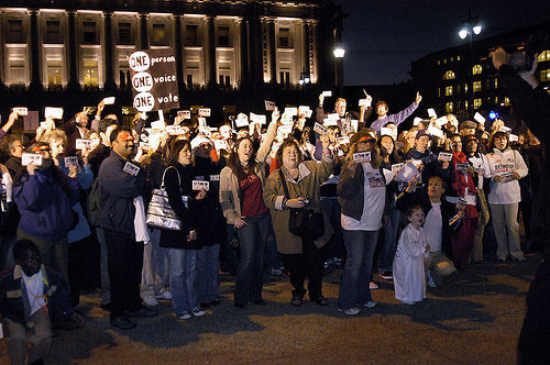 The crowd takes the “stand-up” pledge